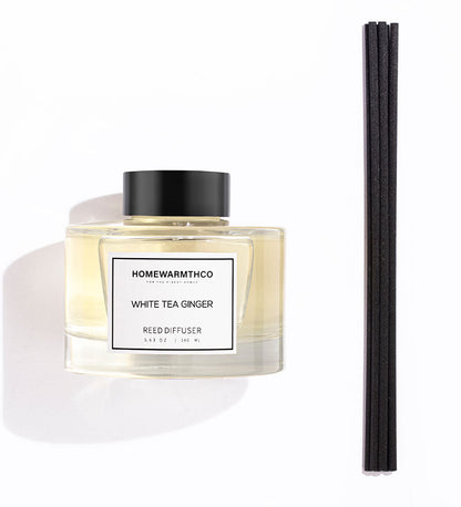 Homewarmthco White Tea Ginger reed diffuser with black sticks on a white background